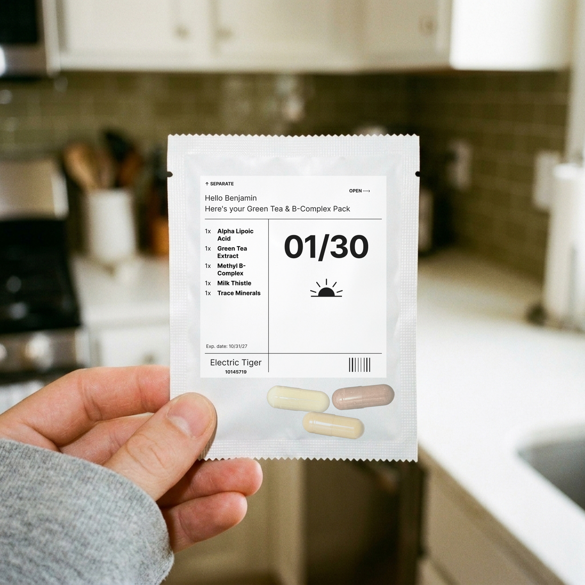 Green Tea & B-Complex Pack: one day's pouch, held up in a kitchen