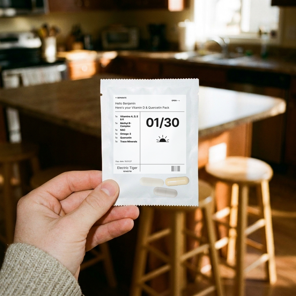 Vitamin D & Quercetin Pack: one day's pouch, held up in a kitchen